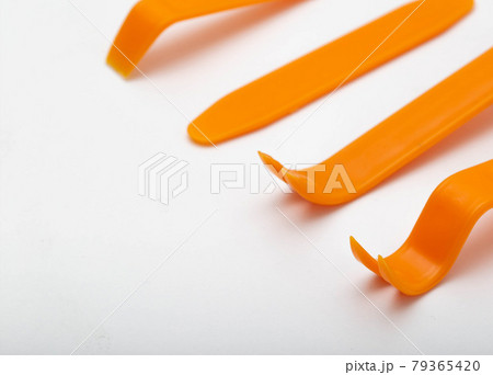 Set of tools for dismantling the interior trim of the passenger compartment on a white background, isolate. Close-up 79365420