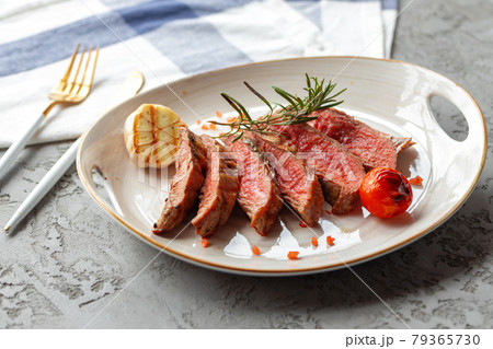 Sliced medium rare grilled steak on plate Sliced medium rare grilled steak on plate 79365730