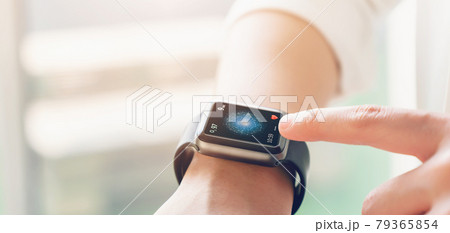hand touching smartwatch with health app on the screen, gadget for fitness active lifestyle. hand touching smartwatch with health app on the screen, gadget for fitness active lifestyle. 79365854