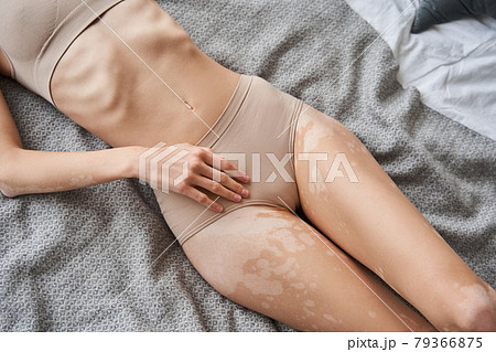 Caucasian woman with strong body laying at the bed and posing at the underwear 79366875