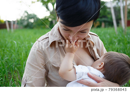 baby boy sucking milk from mothers breast. Portrait of mom and baby. baby boy sucking milk from mothers breast. Portrait of mom and baby. 79368043