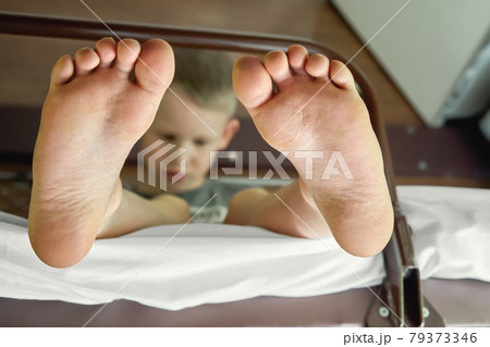 Feet close up. Boy sitting on upper berth in train and plays on the tablet 79373346