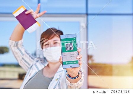 Happy woman holding smartphone displaying on app mobile valid digital vaccination certificate for Covid-19. Immunity vaccine passport, vaccination certificate, health passport for new normal travel Happy woman holding smartphone displaying on app mobile valid digital vaccination certificate for Covid-19. Immunity vaccine passport, vaccination certificate, health passport for new normal travel 79373418