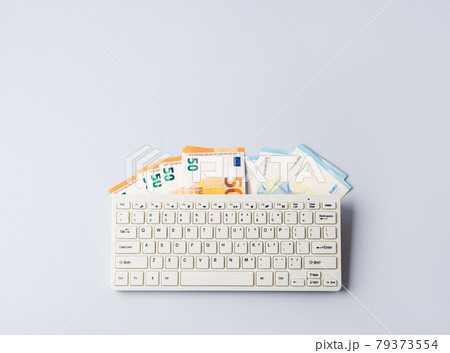 Euro money banknotes under keyboard, online banking, sale of digital info products concept 79373554