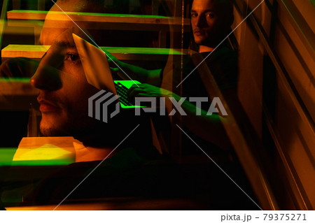 Cinematic portrait of handsome young man in neon lighted room, stylish male model indoors Cinematic portrait of handsome young man in neon lighted room, stylish male model indoors 79375271