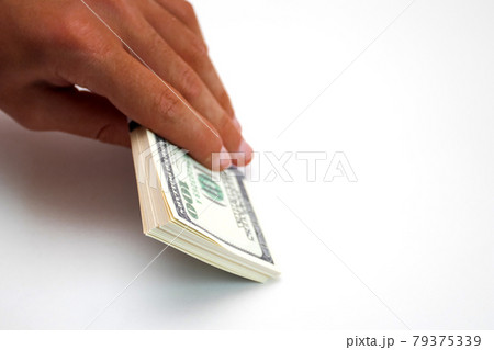 Tanned afro hand holding a bundle of dollars isolated on white background 79375339