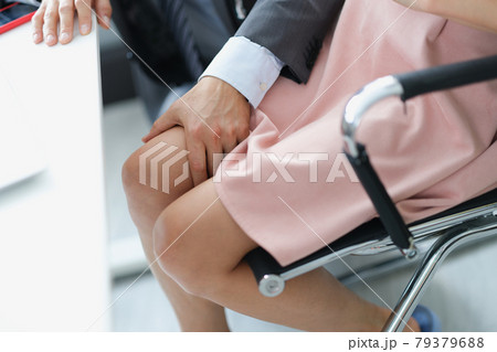 Business man in suit touching knee of woman at work closeup 79379688