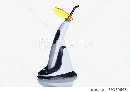 Closeup of dental equipment curing light on white background Closeup of dental equipment curing light on white background 79379693