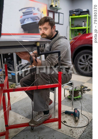 Close shot of dent removing without paint, using rubber hammer  79380370