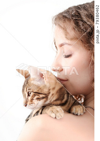 Young beautiful woman with bengal kitten isolated on white background Young beautiful woman with bengal kitten isolated on white background 79380462