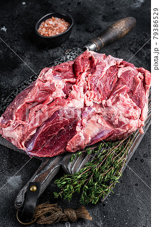 Raw Boneless Leg of Lamb meat on wooden cutting board. Black background. Top view Raw Boneless Leg of Lamb meat on wooden cutting board. Black background. Top view 79386529