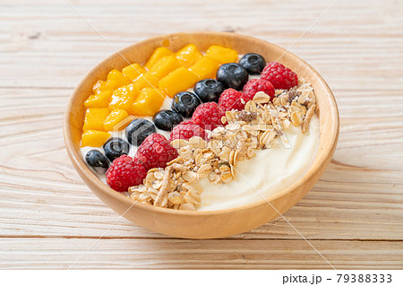 homemade yogurt bowl with raspberry, blueberry, mango and granola 79388333