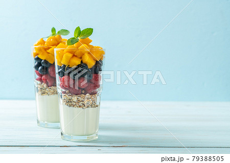 homemade mango, raspberry and blueberry with yogurt and granola 79388505