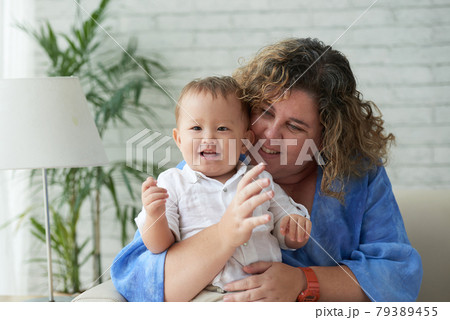 Loving Woman Hugging Son 79389455