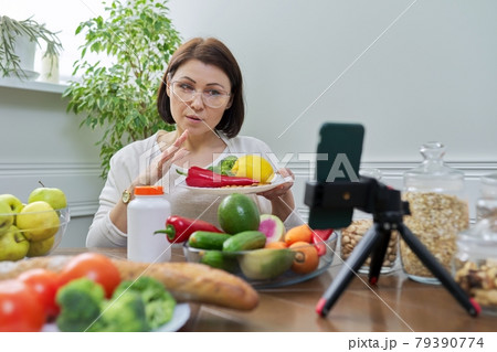 Female nutritionist telling her followers about healthy food, nutritional supplements Female nutritionist telling her followers about healthy food, nutritional supplements 79390774