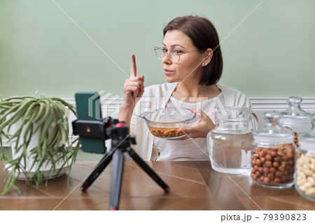 Nutritionist talks about benefits of soaking nuts in water, recording video blog vlog 79390823