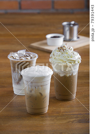 Ice coffee with whipped cream and coffee beans on wooden table. 79391443