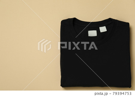 Black sweatshirt on beige background, space for text 79394753