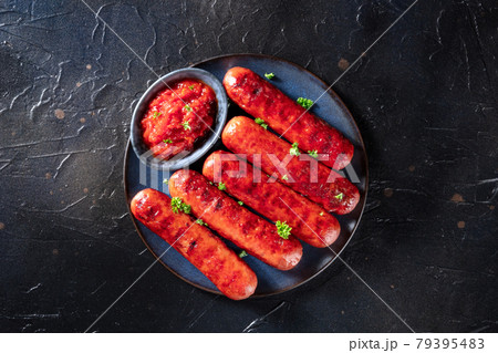 German sausages on a plate with ketchup, shot from the top German sausages on a plate with ketchup, shot from the top 79395483