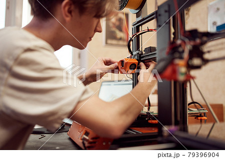 Young man set up 3d printer Young man set up 3d printer 79396904