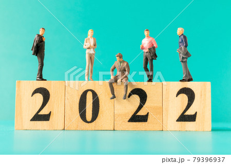 Miniature people : Business people standing on wooden block number 2022 Miniature people : Business people standing on wooden block number 2022 79396937