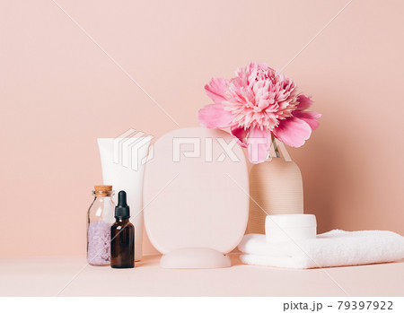 Women's accessories mirror cream oil various cosmetics on a table with flowers. Body and face care health beauty concept Women's accessories mirror cream oil various cosmetics on a table with flowers. Body and face care health beauty concept 79397922