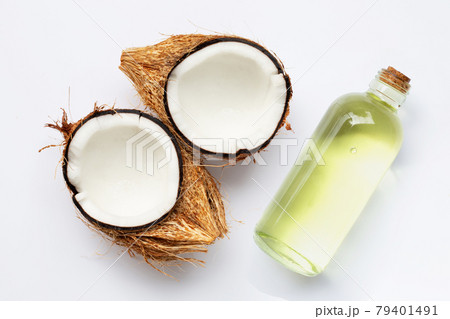Coconut oil with coconuts on white background. Coconut oil with coconuts on white background. 79401491