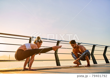 Couple doing practicing yoga together on nature outdoors . Morning exercises at the sunrise. 79401792