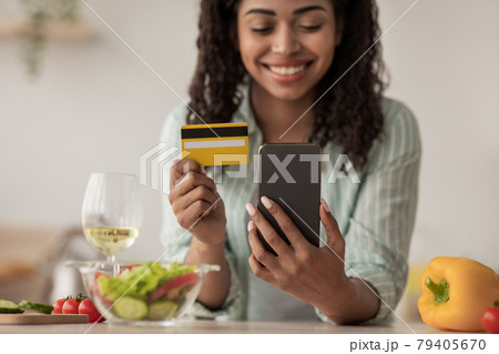 Happy buyer, store customer makes payment with money from banking at home Happy buyer, store customer makes payment with money from banking at home 79405670