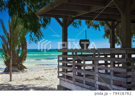 Beautiful views of the Mediterranean coast with birch water, white sand beach and bungalows on the shore Beautiful views of the Mediterranean coast with birch water, white sand beach and bungalows on the shore 79416762