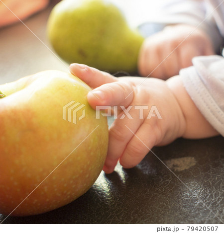 a child plays with a pear 79420507