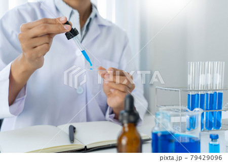 Scientist wear lab coat and protective wear are working with research or doing investigations with test tubes in experiment, Laboratory and development concept Scientist wear lab coat and protective wear are working with research or doing investigations with test tubes in experiment, Laboratory and development concept 79429096