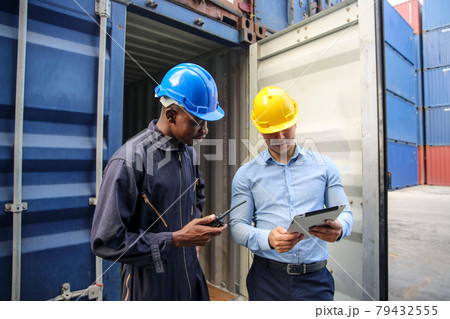 Foreman control loading Containers box from Cargo freight ship for import export. Freight containers in sea port. Cargo ship departure and arrival. Foreman control cargo loading box. Logistics and 79432555