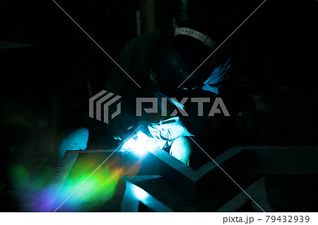 Welder used grinding stone on steel in factory with sparks, Welding process at the industrial workshop, hands with instrument in frame. Welder used grinding stone on steel in factory with sparks, Welding process at the industrial workshop, hands with instrument in frame. 79432939