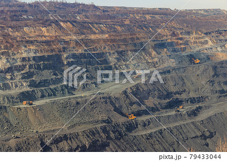 Huge iron ore quarry with working dump trucks and excavators Huge iron ore quarry with working dump trucks and excavators 79433044