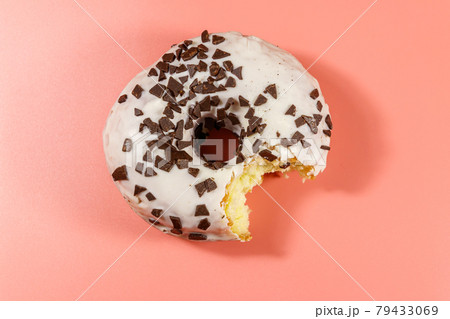 Bitten tasty donut on a pink background. Top view Bitten tasty donut on a pink background. Top view 79433069