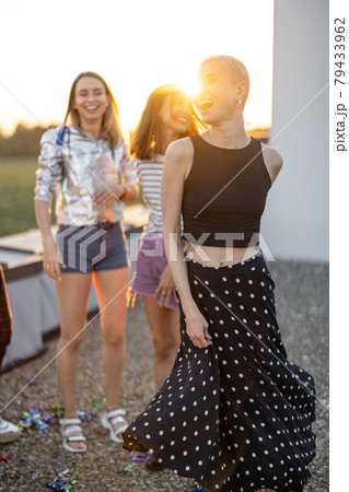 Friends dancing at rooftop terrace on sunset 79433962
