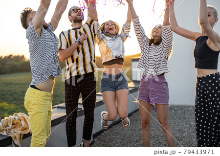 Young friends hang out at rooftop terrace on sunset 79433971