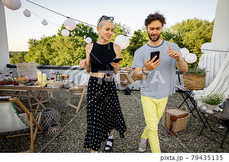 Two friends hanging out at picnic outdoors Two friends hanging out at picnic outdoors 79435135