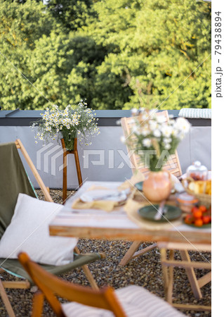 Beautifully decorated roof terrace with a dining table 79438894