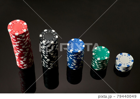 Stack of Casino gambling chips isolated on black reflective background Stack of Casino gambling chips isolated on black reflective background 79440049