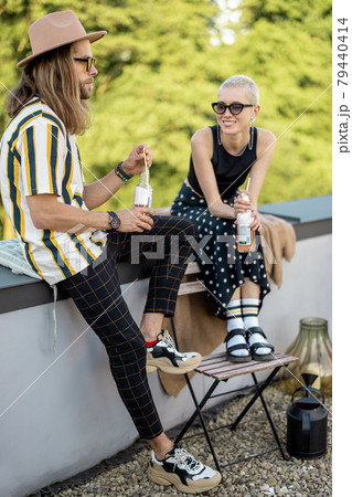 Two friends hanging out at picnic outdoors Two friends hanging out at picnic outdoors 79440414