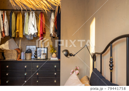 Stylish home wardrobe with clothes in the bedroom 79441758