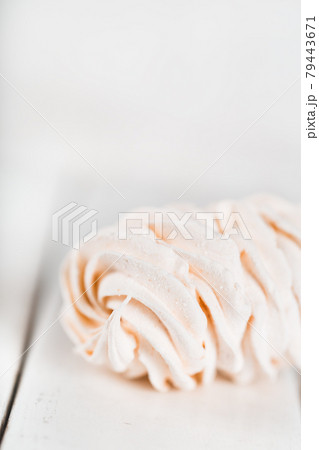 Appetizing white zephyr on a wooden table. Tea drinking concept. Confectionery decoration. Place for text Appetizing white zephyr on a wooden table. Tea drinking concept. Confectionery decoration. Place for text 79443671