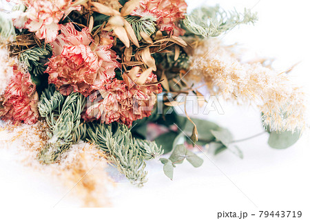 A beautiful bouquet of mix flowers and a branch of a Christmas tree in front of a white background. A gift for any occasion 79443719