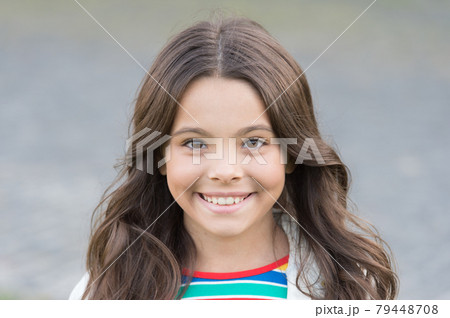 Small girl gorgeous hairstyle adorable smile urban background, happy life concept Small girl gorgeous hairstyle adorable smile urban background, happy life concept 79448708