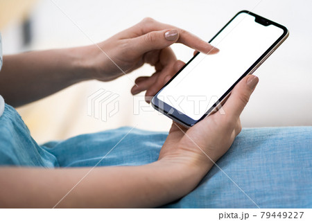 A woman holds a phone with a white screen in her hands. Smartphone in female hands. Modern technologies. 79449227