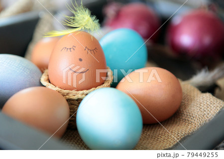 Colorful Easter eggs with smiling emoticon for handpaintings at home. brown eggs face arranged together on the paper background, Selective focus at the eeg. Many colorful organic chicen fresh eggs 79449255
