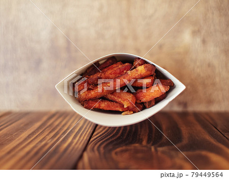 Carrot potatoes in a cardboard box. Instant vegetarian dish. Grilled vegetables. BBQ cooking concept for people who do not eat meat and do not like vegetables Carrot potatoes in a cardboard box. Instant vegetarian dish. Grilled vegetables. BBQ cooking concept for people who do not eat meat and do not like vegetables 79449564