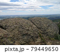 A large stone on the background of mountains with trees 79449650